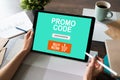 Tablet with promo code field on screen. E-commerce, mobile marketing concept. Royalty Free Stock Photo