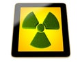 Tablet with radioactivity symbol made from grass on screen