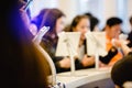 Tablet at register counter for registration in to seminar or meeting with blurry people background. selective focus