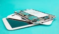 Tablet repair. Close-up disassembled mobile phone parts. Colorful blue background. Royalty Free Stock Photo