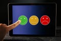 Tablet reviews concept. Different smilings on the gadget. Royalty Free Stock Photo