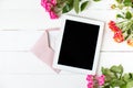 Tablet, roses on the table. Women`s things Fashion womens desk Top view