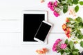 Tablet, roses on the table. Women`s things Fashion womens desk Top view