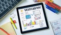 Tablet displaying business analytics charts and graphs on desk Royalty Free Stock Photo