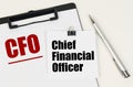 On the tablet, a sheet of paper and stickers with the inscription - CFO, Chief financial officer