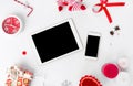 Tablet smartphone composition for christmas time. Christmas gifts and christmas decorations on white background. Royalty Free Stock Photo