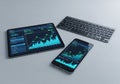 A tablet, smartphone, and wireless keyboard are arranged on a light Royalty Free Stock Photo