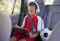 Tablet, sports and relax child on car travel transportation to soccer, football or match game in SUV van with safety Royalty Free Stock Photo