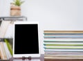 Tablet and stack of books on table Royalty Free Stock Photo
