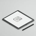 A tablet with a stylus lying on a light gray surface. The tablet screen displays a simple, Royalty Free Stock Photo