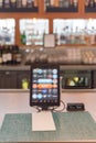 Tablet with swipe magnetic credit card reader to order food and drink at airport bar restaurant in Texas, USA Royalty Free Stock Photo