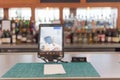 Tablet with swipe magnetic credit card reader to order food and drink at airport bar restaurant in Texas, USA Royalty Free Stock Photo