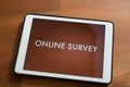 Tablet on table with online customer survey Royalty Free Stock Photo