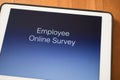 Tablet on table with online employee survey Royalty Free Stock Photo