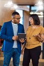 Tablet, team or business people talking in office with ideas, internet and diversity. A professional man and woman Royalty Free Stock Photo