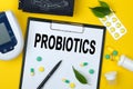 Tablet with text PROBIOTICS. Nearby is a tonometer, medicines, vitamins and a pen