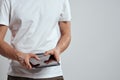 Tablet with a touch screen on a light background male hands white t-shirt cropped view Royalty Free Stock Photo