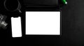 Tablet touchscreen and smartphone white display mockup on black worktable Royalty Free Stock Photo