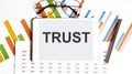 The tablet with TRUST on a chart Royalty Free Stock Photo