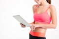 Tablet used by slim beautiful young sportswoman Royalty Free Stock Photo