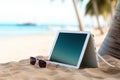 Tablet by the waves Close up view of digital device against tranquil beach