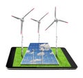Tablet with a wind turbines and solar panel Royalty Free Stock Photo