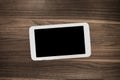 Tablet on wooden desk table. Royalty Free Stock Photo