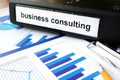 Tablet with word business consulting and graphs.