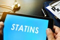 Tablet with word statins. Royalty Free Stock Photo