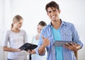 This tablet works perfectly. A handsome young man holding a digital tablet and giving you the thumbs up with his Royalty Free Stock Photo