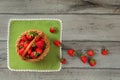 Tabletop photo, basket with strawberries , some of them spilled