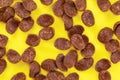 Tabletop photo, chocolate corn flakes on yellow board