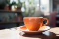 Tabletop serenity an orange coffee cup at rest