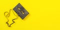 Tabletop view, audio cassette with some tape out on yellow background. Wide banner space for text right Royalty Free Stock Photo