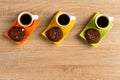 Tabletop view of delicious chocolate biscuits and three cups of coffee Royalty Free Stock Photo