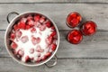 Tabletop view - large steel pot with strawberries covered in cry Royalty Free Stock Photo