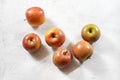 Tabletop view - red / yellow apples kiku variety on white working board