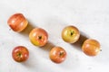 Tabletop view, six shiny apples kiku variety on white working board