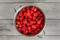 Tabletop view, steel pot full of strawberries with leaves remove Royalty Free Stock Photo