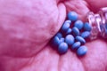 Tablets amphetamines poured from a glass container in hand close-up macro Royalty Free Stock Photo