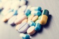 Tablets on a black background. Reflection of pills on a glass. MedicineÃÂ´s background. Pharmacy. Close up of capsules