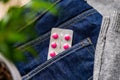 Tablets in blister in jeans pocket. The concept of antidepressants and healing