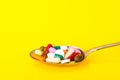 Tablets, capsules, pills in spoon on bright background. The concept of medicine and health Royalty Free Stock Photo