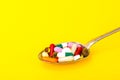 Tablets, capsules, pills in spoon on bright background. The concept of medicine and health Royalty Free Stock Photo