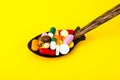 Tablets, capsules, pills in spoon on bright background. The concept of medicine and health Royalty Free Stock Photo