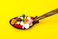 Tablets, capsules, pills in spoon on bright background. The concept of medicine and health Royalty Free Stock Photo