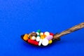 Tablets, capsules, pills in spoon on bright background. The concept of medicine and health Royalty Free Stock Photo