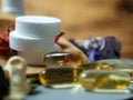 Tablets and capsules in a wooden spoon.