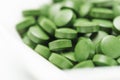 Tablets of Chlorella - green algae Royalty Free Stock Photo