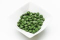 Tablets of Chlorella - green algae Royalty Free Stock Photo